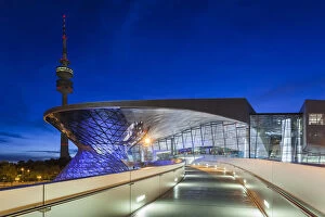 Germany, Bavaria, Munich, BMW Welt company showroom and Olympia Tower, dusk