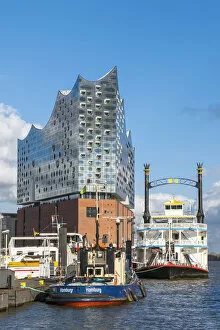 Images Dated 7th July 2017: Germany, Hamburg, HafenCity. Boats docked near the Elbphilharmonie (Elbe Philharmonic