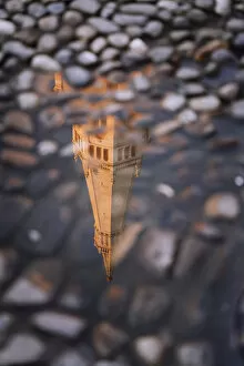 Ghirlandina tower reflecting on water in Piazza Grande, Modena, Emilia Romagna, Italy