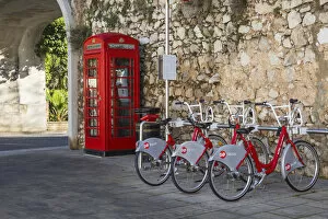 Bicycle Gallery: Gibraltar, Gibraltar, British red telephone box and hire bikes by Southport Gates