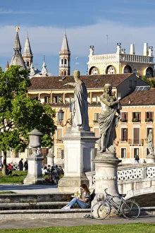 A girl reading in Prato della Valle, Padova, Veneto, Italy, Europe