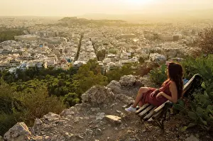 Lonely Prints: Girl seated on a bench at the Viewpoint of Athens at the lycabettus mount, Athens, Greece