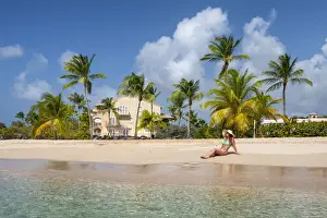 Girls Prints: Girl sunbathes on the beach facing the turquoise water of the Caribbean sea