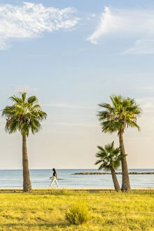 Images Dated 8th July 2021: A girl walking along Palm Beach in Larnaca, Cyprus