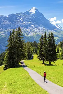 Girl Prints: Girl walking along path towrds the Eiger mountain, Canton of Bern, Switzerland. (MR)