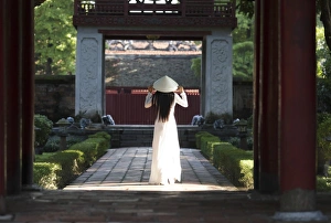 Girl wearing Ao Dai dress and Non La conical hat, Temple of Literature, Hanoi, Vietnam