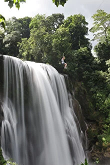 Honduras Gallery: Girl on zip line over waterfall, Cascadas Pulhapanzak, Waterfalls, Honduras.MR