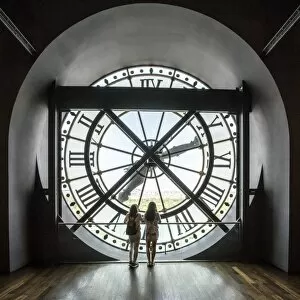 Paris Gallery: Two girls looking through a giant clock in Musee d Orsay, Paris, France