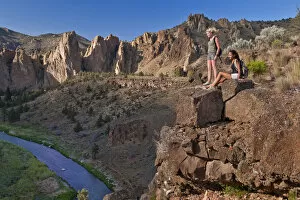 Two girls resting on cliff face, Smith Rock State Park, Central Oregon, USA MR
