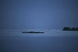 Gisenyi, Rwanda. Night fishermen head out onto lake Kivu with specially adapted boats
