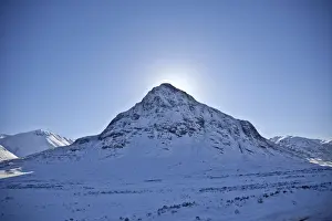 Bute Prints: Glen Coe, Scotland. The sun hides behind Meall Mor in snow covered Glen Coe
