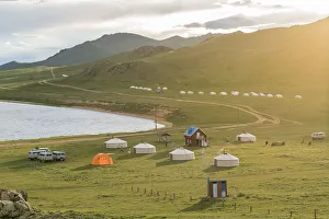 Golden light on a family ger camp on the shores of White Lake