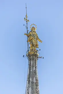 The golden statue called La Madonnina on the top of the Duomo the icon of Milan Lombardy
