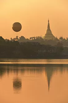 Images Dated 22nd April 2021: The golden stupa of the Shwedagon Pagoda and the Mingalarbar hot air baloon reflected in