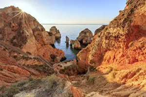 Golden sunrise on the red cliffs of Ponta da Piedade Lagos Algarve Portugal Europe