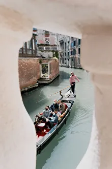 Gondolier Prints: gondalier row his traditional boat in Venice canal, Veneto, Italy