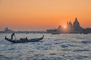 North Italy Collection: Gondola on the Grand Canal at sunset with Basilica of Saint Mary of Health in background