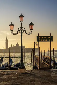 Service Prints: Gondola service sign and Church of San Giorgio Maggiore in the background at sunrise Venice