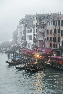 Gondolas near Rialto bridge during a cloudy day. Venice, Veneto, Italy