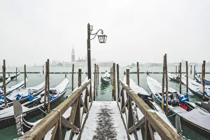 Gondolas with snow at St Marks waterfront, Venice, Veneto, Italy