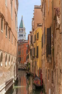 Images Dated 25th May 2022: Gondolier and gondola in San Marco, tower on background. Venice, Veneto, Italy