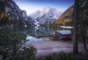 The grand view of the lonely cabin on the Braies lake (Pragser Wildsee) during a calm autumn morning. Dolomites, Italy