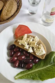 Appetizer Prints: Greek Cuisine. Traditional Meze (Starter) Cretan Dakos with a glass of Ouzo