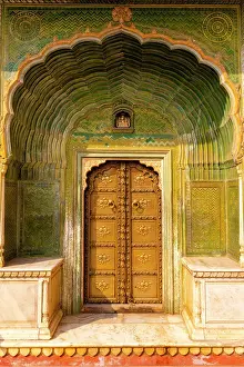 Gate Prints: Green Coloured Leheriya Gate with a Ganesha Carving Visible Above the Door