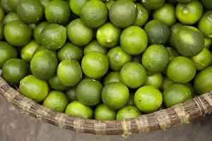 Images Dated 10th October 2012: Green Tangerines in a basket, Old Quarter, Hanoi, Vietnam