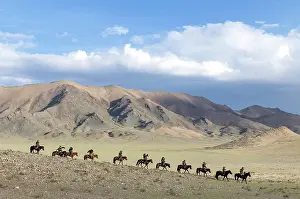 Mongolia Prints: Group of Kazakh Eagle hunters in the mountains on horseback with their trained golden eagles