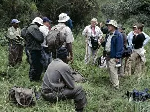 Rwanda Gallery: A group of tourists is briefed by parks staff of the