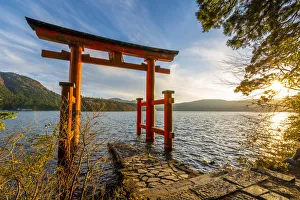 Hakone, Kanagawa Prefecture, Honshu, Japan. Red torii gate at lake Ashi