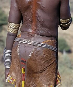 Traditional Attire Gallery: A Hamar woman is left with bloody wheals