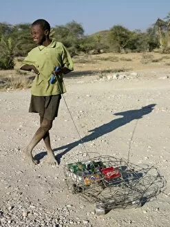 Damaraland Gallery: A happy youth with his ingenious homemade wire lorry