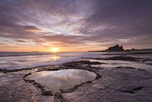 Images Dated 9th March 2015: Heart shaped pool on Bamburgh Beach at sunrise, Northumberland, England. Spring