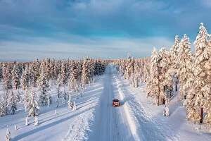 Adventure Gallery: High angle car driving on an icy road among trees covered with snow, Kangos, Lapland, Sweden