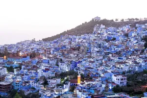 Crowded Prints: High angle view of the fairy tale blue city of Chefchaouen at dusk, Morocco