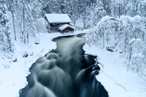Rime Ice Prints: High angle view of icy river rapids flowing in a winter snowy forest near Myllykoski mill