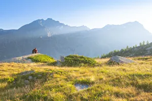 Levanne Prints: An hiker admires the sunset near Refuge Jervis, Valle dell Orco