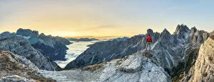 Dolomitic Collection: Hiker admiring the Dolomites at sunrise in front of Cadini di Misurina, Auronzo di Cadore