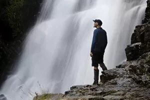 Central Highlands Gallery: A hiker enjoys Fergusson Falls on the Overland Track