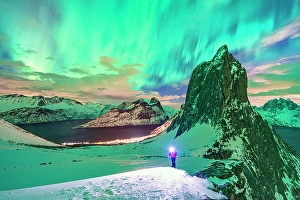 Aurora Borealis Prints: Hiker looking at the Northern Lights over mount Segla, Senja, Troms county, Norway