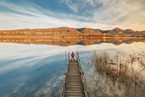 Piers Prints: Hiker on the pier looks Alserio lake