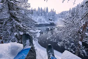 Juuma Prints: Hiker rests on the snow above Myllykoski rapids, Juuma, Oulanka National Park, Kuusamo