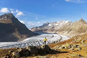 Admiring Prints: A hiker standing on top of a rock looking at the view of the Aletsch glacier