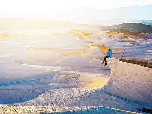 Sitting Prints: Hiker watching sunrise over pumice fields