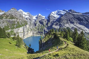 Hikers around Lake Oeschinensee Bernese Oberland Kandersteg Canton of Bern Switzerland