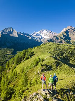 Clear Sky Prints: Hikers look towards Monte Disgrazia from Scermendone Alp, Sondrio province, Valtellina
