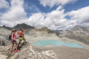 Outdoor Pursuits Prints: Hikers looking the alpine view of Lej Lagrev, Silvaplana, Canton of Graubunden, Engadine