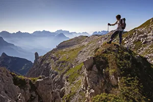 Hikers near Passo del Ciodo looking at the landscape, in the bottom the curious bell